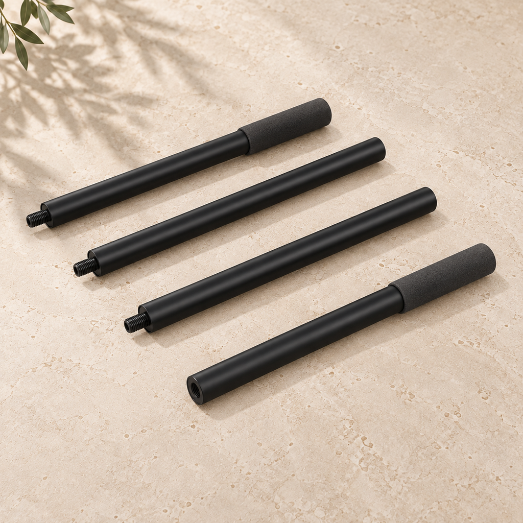 Four black SÖM Mobility Stick sections with threaded connectors and two foam grips, arranged on a pale stone surface.