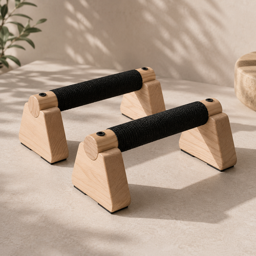 Pair of wooden SÖM Push-Up Bars with black wrapped grips on a light stone surface.